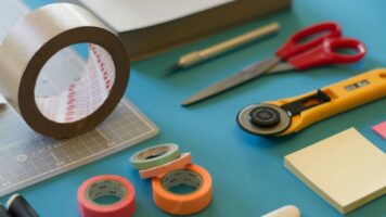photograph of miscellaneous zine-making tools including tape and scissors